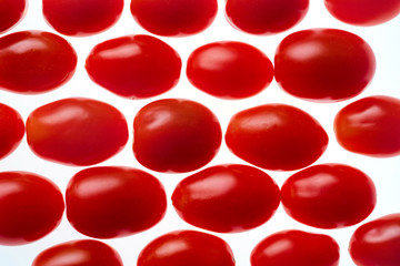 grape tomato in rows on a white background