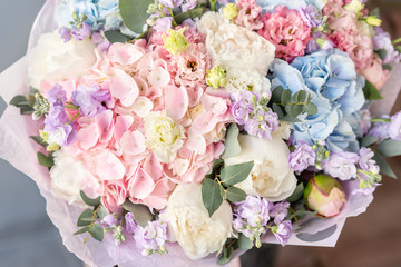 Large Beautiful bouquet of mixed flowers in woman hand. Floral shop concept . Beautiful fresh cut bouquet. Flowers delivery