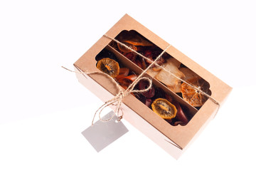 Box with marshmallow and dried fruit on a white background