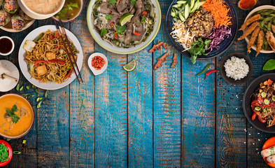Asian food background with various ingredients on rustic wooden table , top view. Vietnam and Thai cuisine.