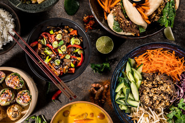 Asian food background with various ingredients on rustic stone background , top view. Vietnam and Thai cuisine.