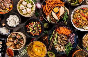 Asian food background with various ingredients on rustic stone background , top view. Vietnam and Thai cuisine.
