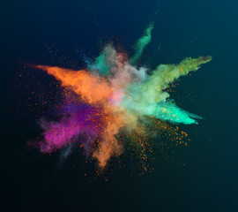 Colored powder explosion on dark gradient background. Freeze motion.