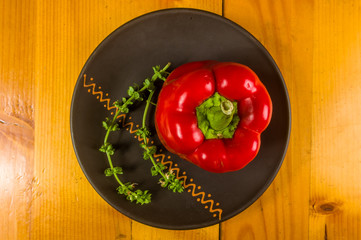 a freshest red paprika, bell pepper in ceramic plate