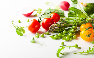 Fresh green  peas pods, radish, green asparagus, tomatoes