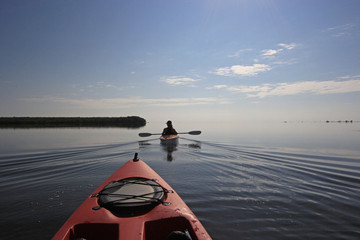 Kayaker enjoying a very calm early morning paddle on Biscayne Bay in Biscayne National Park, Florida