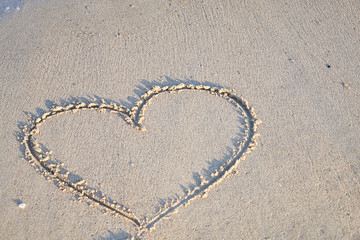 Love message on the beach sand - vacation and travel concep