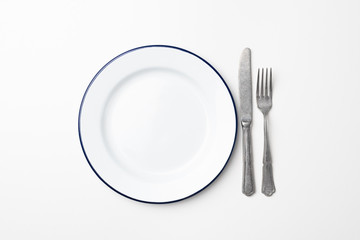 Empty plate and cutlery on white background, top view. Table setting