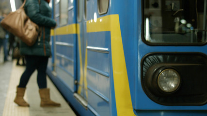 Fototapeta na wymiar Close up view of train at indoor subway station. Metro subway train in station close up. Passengers enter the subway wagon.