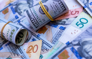 Cash money closeup: dollars and rubles. Financial concept to illustrate currency exchange, earnings, wages and trading.
