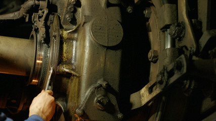 Mechanic repairing a car close up. Locomotive in the repair workshop for trains stock. Repair of trucks.