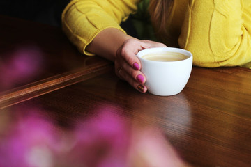 hands holding hot cup of coffee