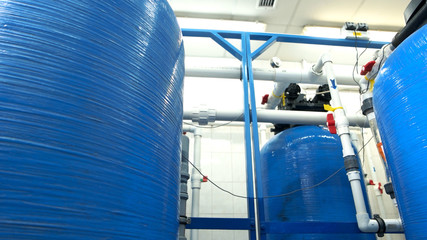 Industrial water filters. White pipes and red valves. Purification of water at plant. Newest...