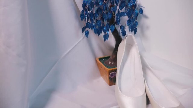 Bride's wedding shoes and decorative flower