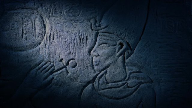 Torch Lights Up Egyptian Carving Of Man