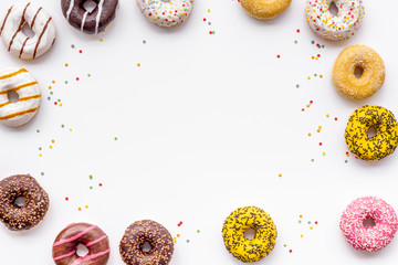 Traditional american donuts of different flavors frame on white background flat lay mockup