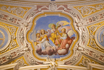OSSUCCIO, ITALY - MAY 8, 2015: The baroque fresco choir of angels with the music instruments in church Sacro Monte della Beata Vergine del Soccorso by Salvatore Pozzi di Puria  (1595 – 1681).