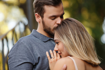 Fototapeta premium Beautiful couple in love, man kisses his woman