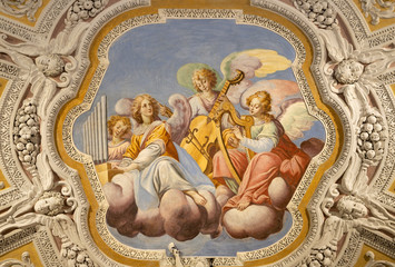 OSSUCCIO, ITALY - MAY 8, 2015: The baroque fresco choir of angels with the music instruments in...