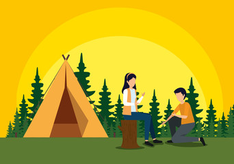 woman sitting in the tree trunk and man with camp