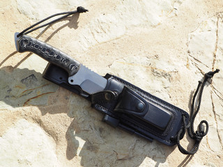 Big Survival Knife is on the stone. View from above.
