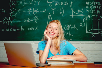 College students studying. Education. Student girl reading a presentation on laptop. Education study abroad. Female student looking at camera