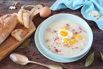Traditional polish soup Zurek. Sour soup with sausage,  potatoes and eggs