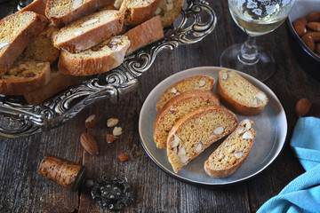 Italian cookies: almond cantuccini and glass of white wine