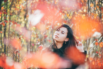 Female beauty portrait surrounded by vivid foliage. Dreamy beautiful girl with long natural black...
