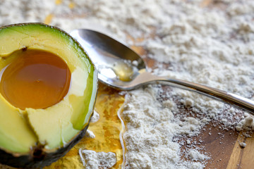 Honey avocado spoon flour on wooden