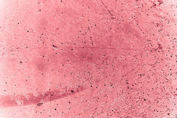 Vintage pink background. Rough painted wall of fiesta color. Imperfect plane of rosy colored. Uneven old decorative toned backdrop of rouge tint. Texture of pink hue. Ornamental stony surface.