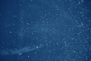 Vintage blue background. Rough painted wall of sapphire color. Imperfect plane of blue colored. Uneven old decorative toned backdrop of cyan tint. Texture of sapphirine hue. Ornamental stony surface.