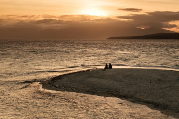 silhouette of man on beach at sunset