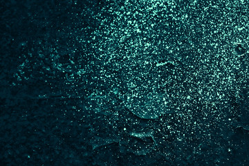 Vintage azure background. Rough painted wall of turquoise color. Imperfect plane of cyan colored. Uneven old decorative toned backdrop of aqzure tint. Texture of teal hue. Ornamental stony surface.