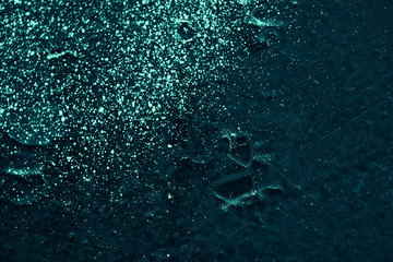 Vintage azure background. Rough painted wall of turquoise color. Imperfect plane of cyan colored. Uneven old decorative toned backdrop of aqzure tint. Texture of teal hue. Ornamental stony surface.