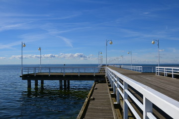 Naklejka premium Wooden pier in Jurata town at sunny, summer day. Coast of Baltic Sea at Hel peninsula, Poland