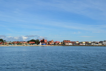 Fototapeta na wymiar Hel, Poland. View from the sea on the town, beach and breakwater. Sunny day on Hel Peninsula