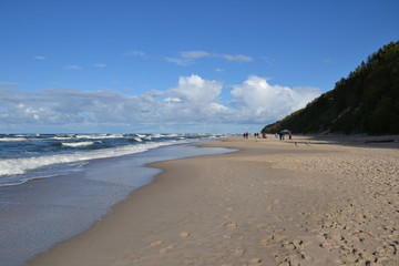 Beautiful sandy beach and rough sea on a cool autumn day. Baltic Sea coast, Poland, Europe