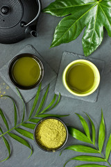 Obraz na płótnie Canvas Ceramic bowsl of matcha tea on grey texture background