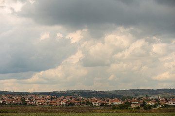 Thunderhead covers the Balkans. Downpour is approaching agricultural land. Bulgarian villages...