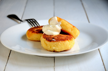 Cheesecakes on a white plate, on a white background.