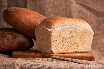 loaf of bread, concept of home food close up on sacking background