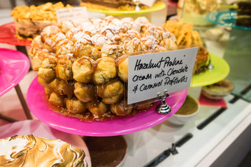 Hazelnut praline cream with caramel profiteroles dessert on display in a restaurant