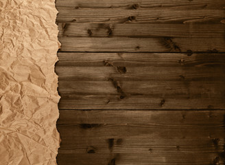 Crumbled brown packing paper on brown wooden kitchen table with copyspace