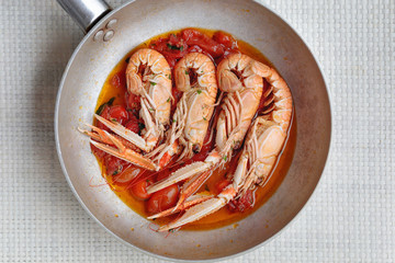 Scampi cooked with cherry tomato sauce
