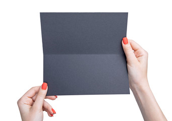 A woman holding black booklet