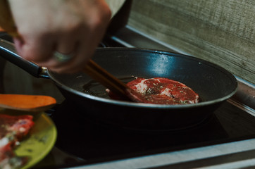 Making dinner in restaurant. Professional cooker