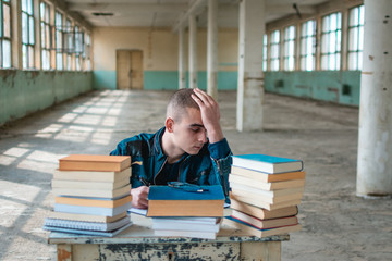 Photo of a student having difficulty while studying for the exam.