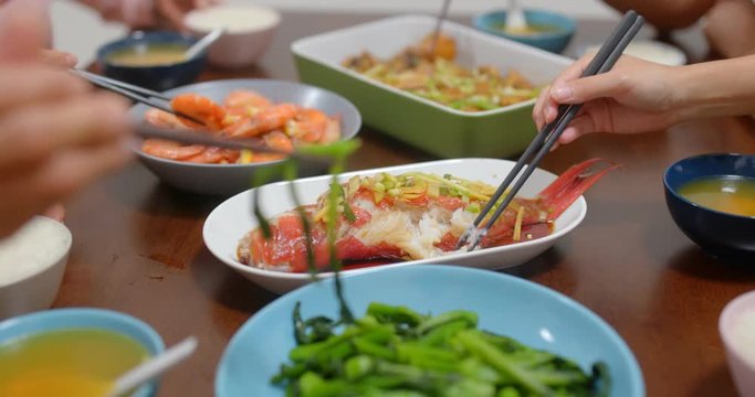 Family dinner with steamed fish and vegetable at home