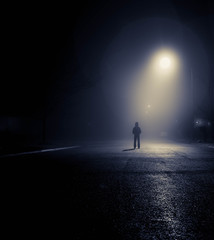 person standing under streetlight